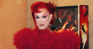 Krystal Queer dressed in red, with red hair to match.