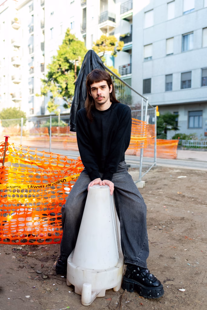 Elska Milan model Alessandro Florio photographed by Liam Campbell. Alessandro is posing in an industrial environment.