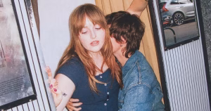 Promotional image of Nell Mescal, with her partner Madison Cawley embracing her.