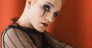 This article is about Genderfluid Visibility Week. The image depicts a person with makeup